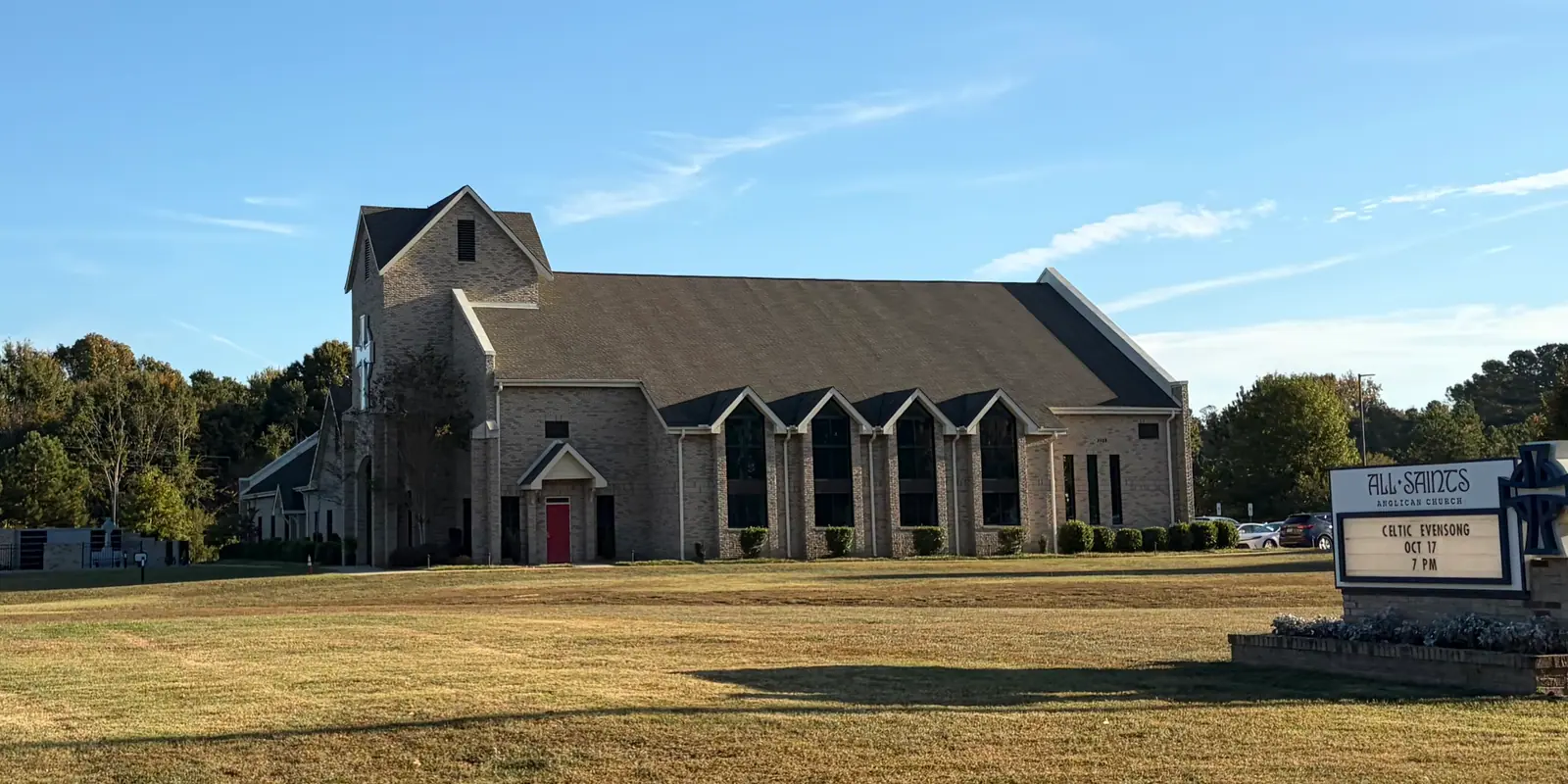 Evening choral concert and community holiday carols performance inside an architectural stone chapel