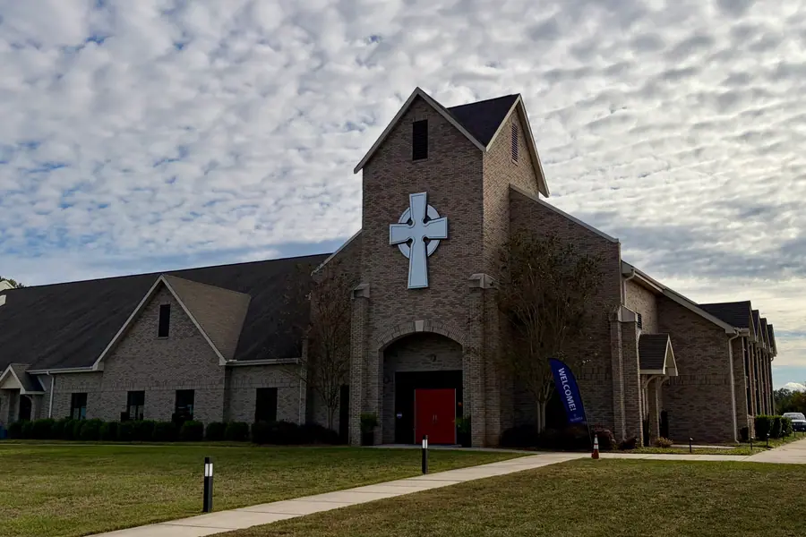 Gothic architectural facade and arched stone entrance of All Saints Anglican Church in Weddington, North Carolina