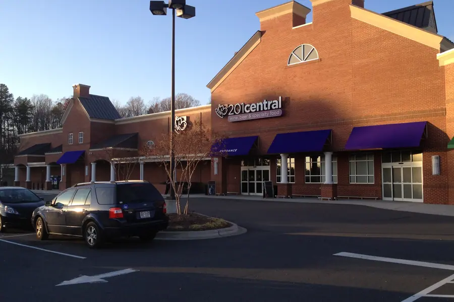 Classical brick retail colonnade and commercial storefronts at Wesley Chapel Village Commons along Weddington Road