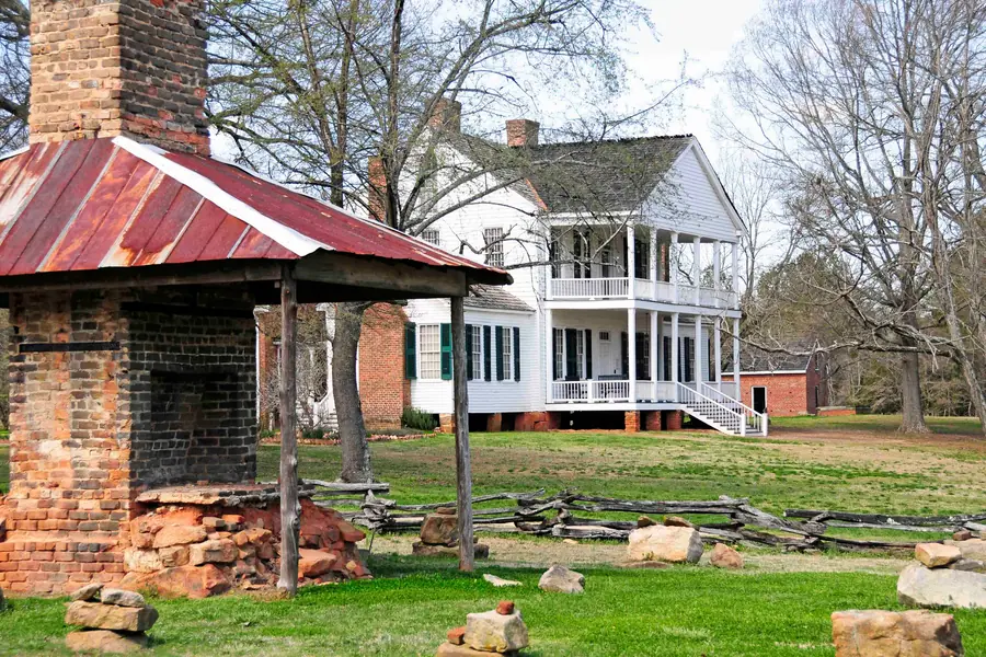 Preserved historic plantation estate buildings and split-rail fence at Historic Brattonsville in York County