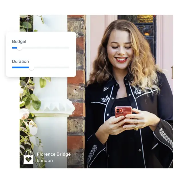 Shop owner checking ad budget and duration on her phone