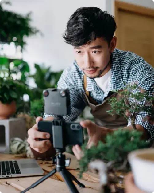Local content creator filming a product video on a phone mounted on a tripod