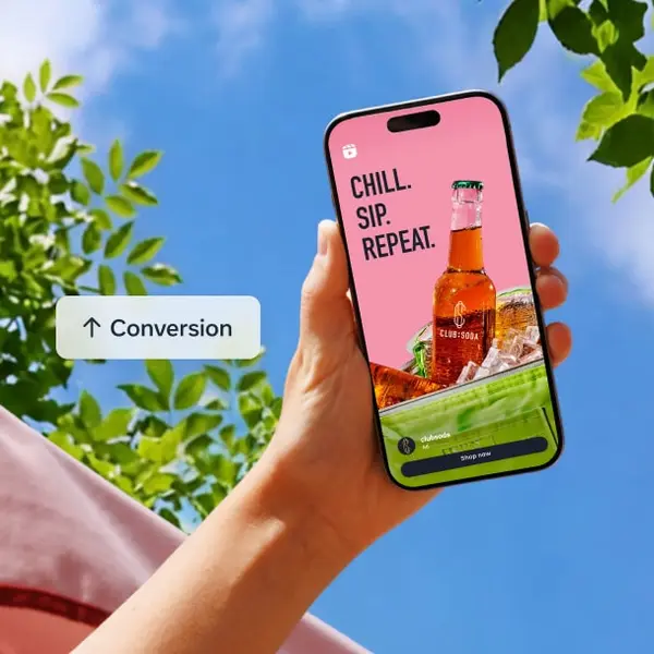 Hand holding a phone showing a Meta ad that leads to a purchase