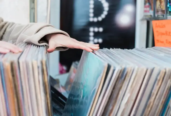 Hands flipping through records, a returning customer browsing again