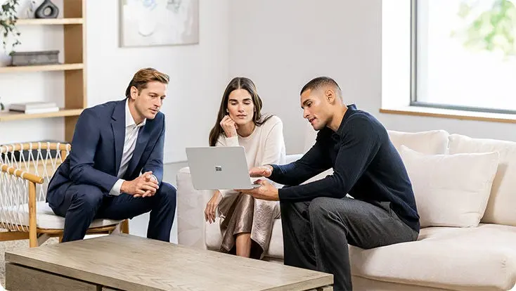 Agency strategist walking a client through a campaign plan on a laptop
