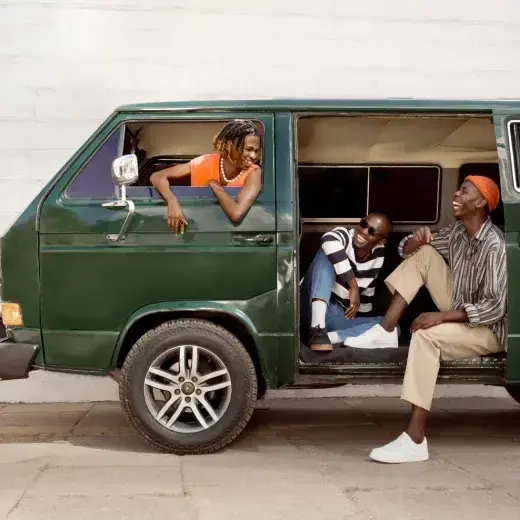 Friends in a parked van listening to music together