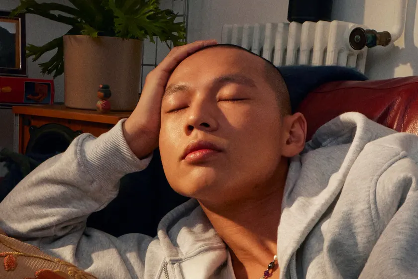 Young man resting at home with his eyes closed while listening
