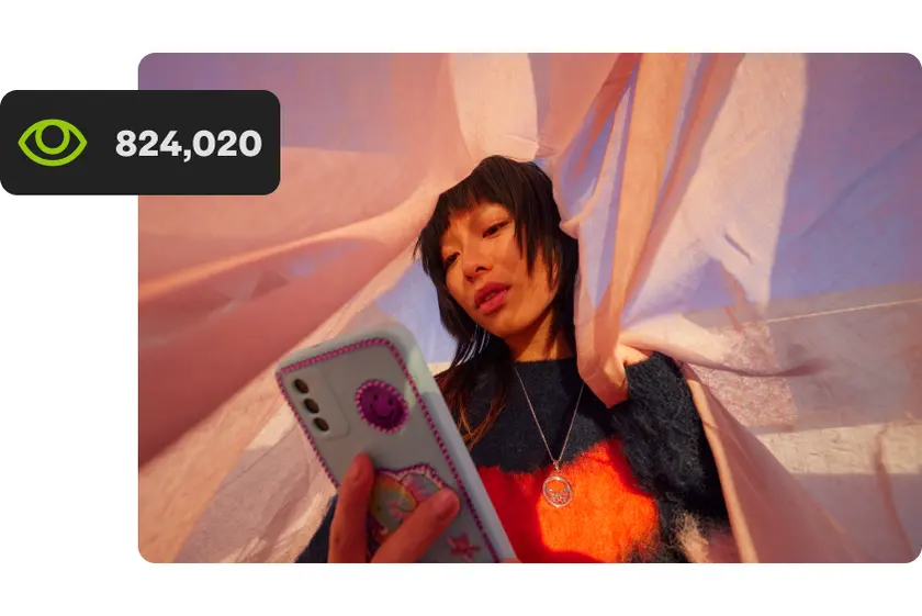 Young woman watching a video ad on her phone with a view count beside her