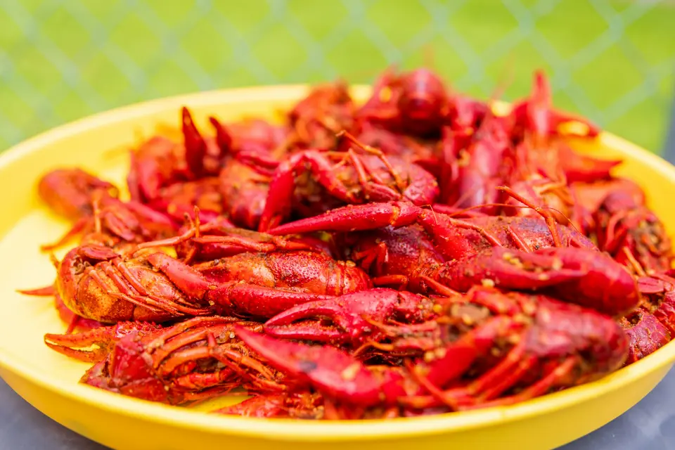 Yellow bowl piled with bright red boiled crawfish