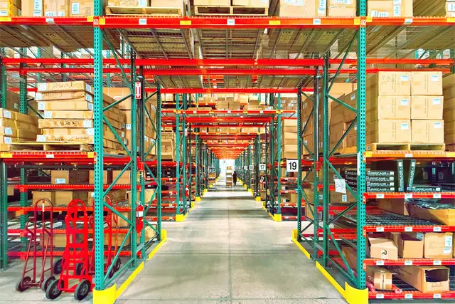 Distribution warehouse aisle with tall racks of boxed stock