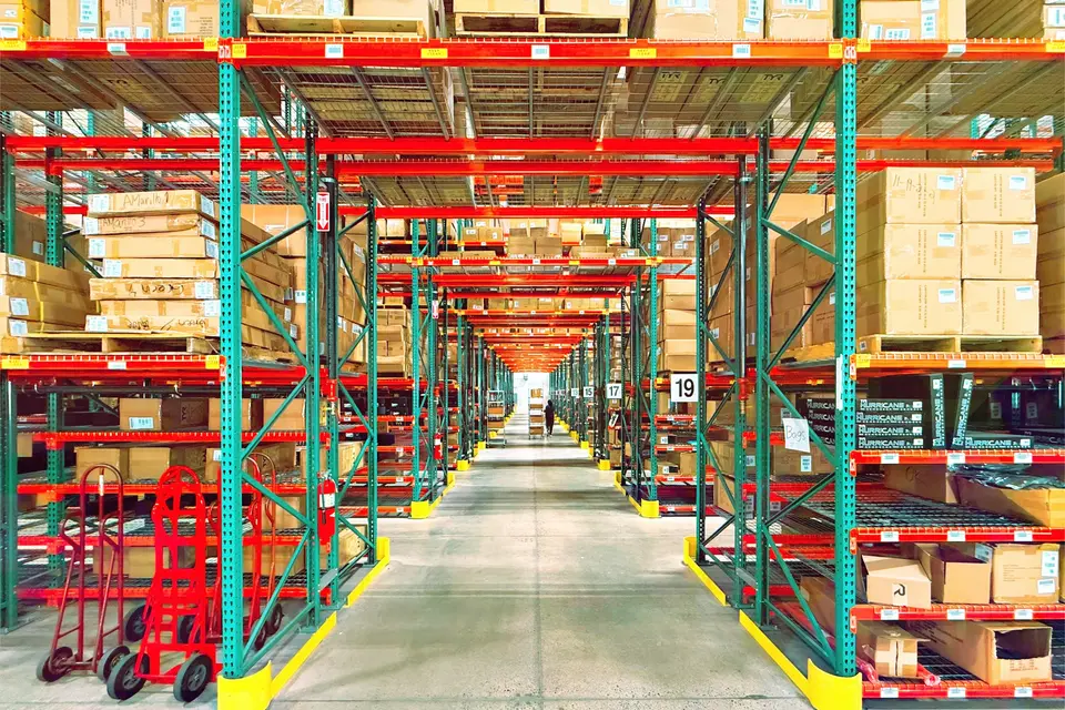 Distribution warehouse aisle with tall racks of boxed stock
