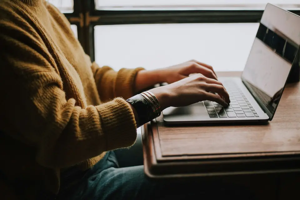 Person studying an online course on a laptop at a desk