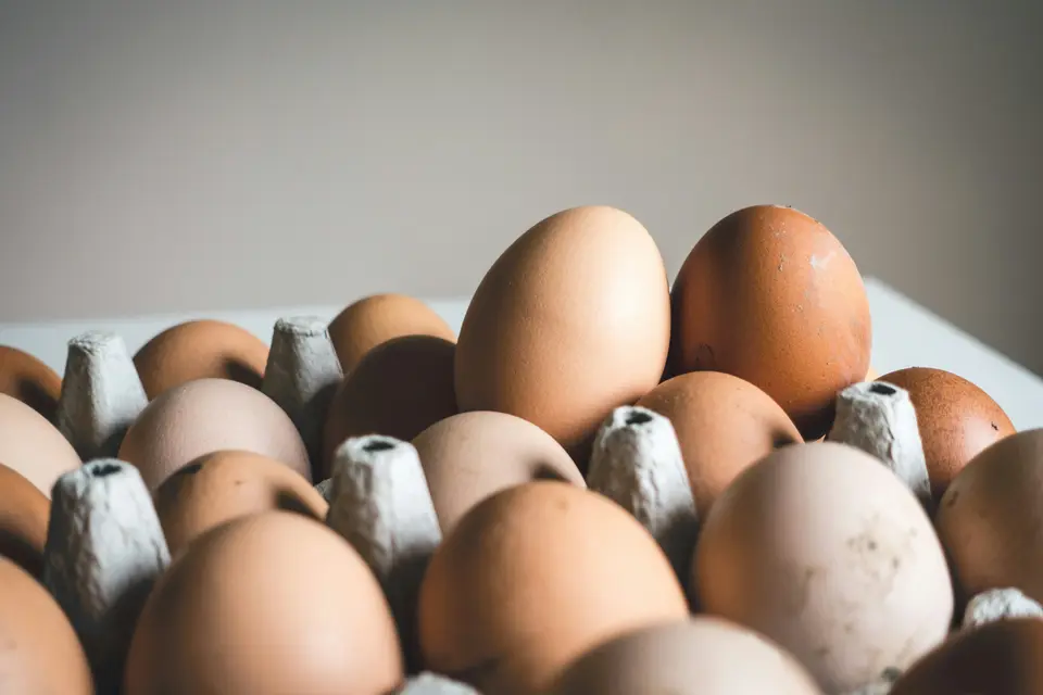 Fresh brown eggs arranged in a tray