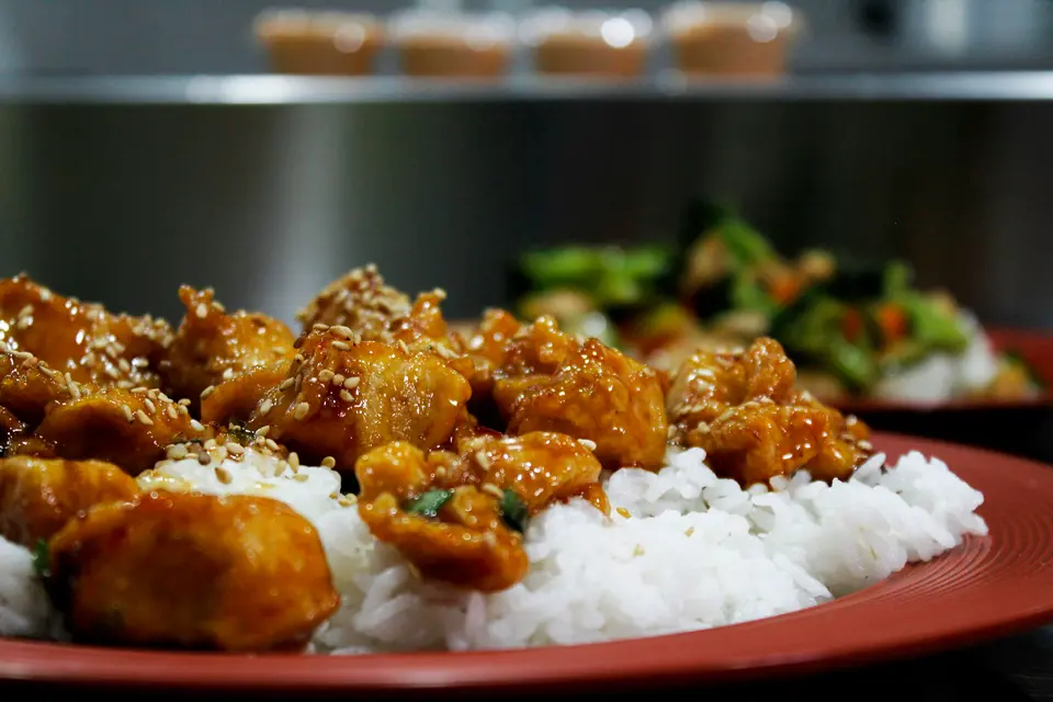 Glazed teriyaki-style chicken with sesame seeds over white rice
