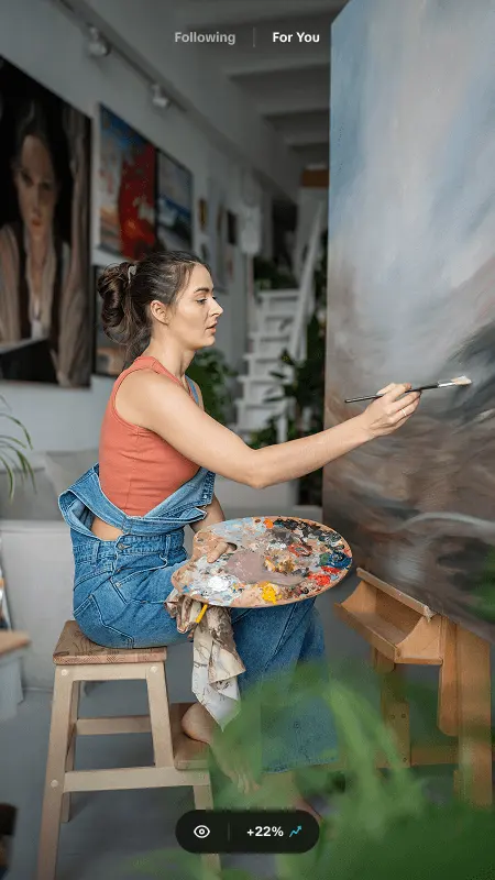 Painter working on a canvas in her studio, shown as a creator-style TikTok video ad