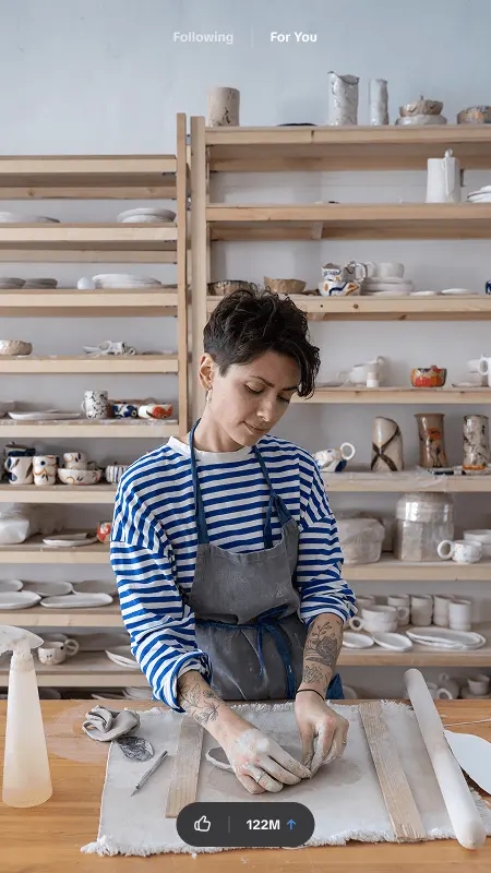 Ceramics studio owner shaping clay, shown as a video in the TikTok For You feed