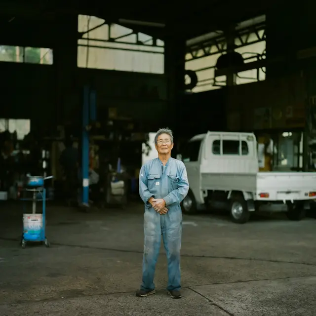 Auto repair shop owner standing in his garage