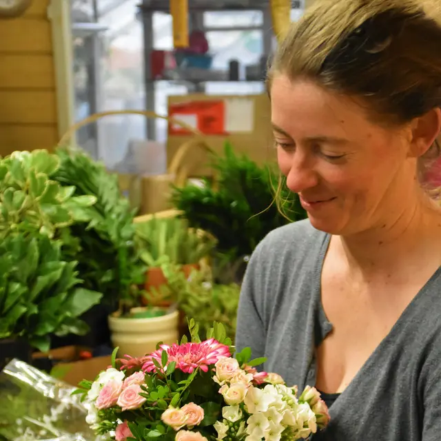 Florist arranging a bouquet in her flower shop