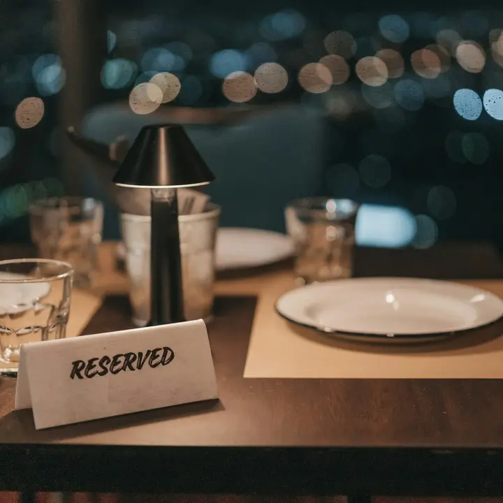 Reserved card on a set restaurant table in the evening